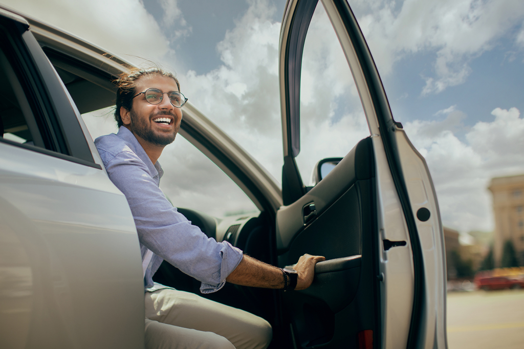 Positive,Young,Middle-eastern,Man,Going,Out,The,Car,,Low,Angle